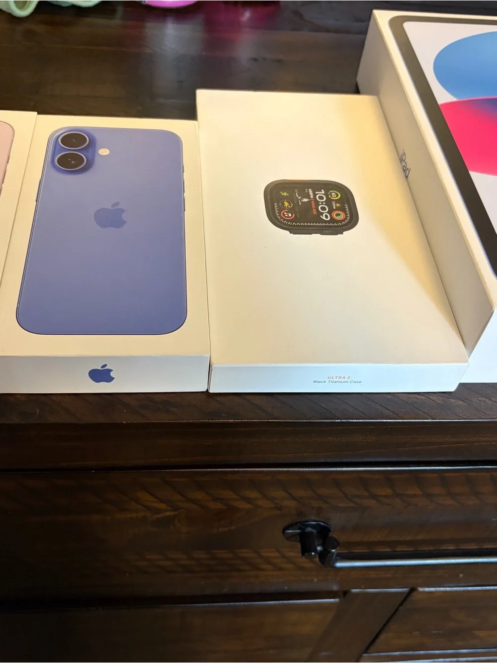 Apple empty boxes in Lavender and Blue with Apple Watch and iPad empty boxes.